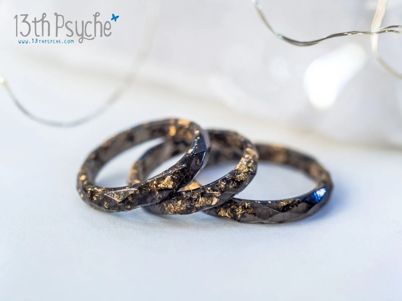 Black faceted resin ring with gold flakes