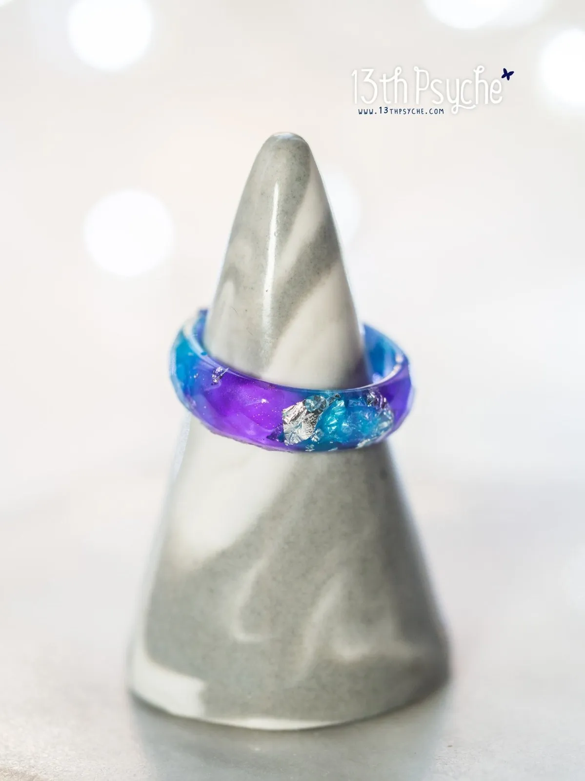 Purple and blue faceted resin ring with silver flakes